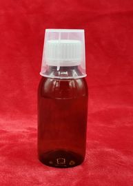 Σπασμένο μπουκάλι σιροπιού ιατρικής απόδειξης, πλαστικά εμπορευματοκιβώτια σιροπιού με τη μέτρηση του φλυτζανιού